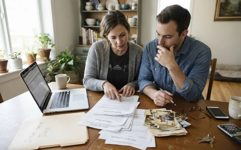 A family reviewing paperwork together after inheriting a home with an outstanding mortgage